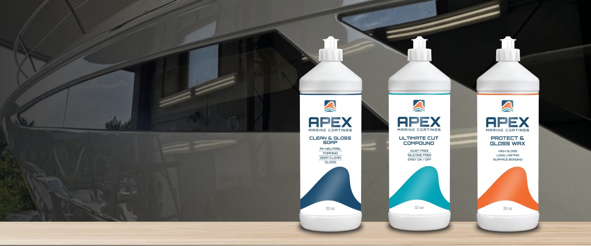 Three bottles of Apex car care products on a wooden surface with a car in the background.